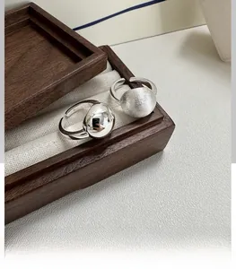 Detail of S925 sterling silver ball rings showing polished and brushed textures