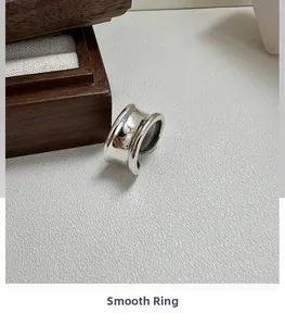 Macro shot of minimalist silver curved ring with premium polished mirror finish