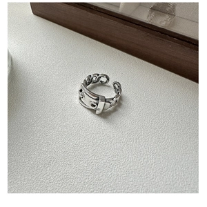 Detailed close-up of a vintage belt buckle design silver ring with chain links and open band