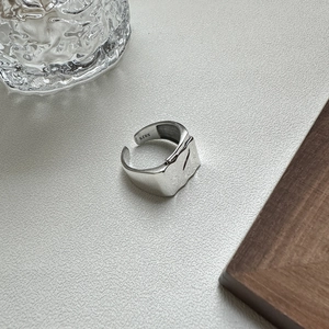 S925 sterling silver open ring with irregular lava texture on white minimalist surface