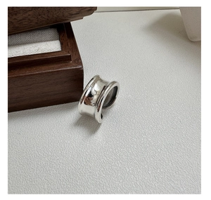 Detailed view of irregular wide curved S925 sterling silver ring with polished finish