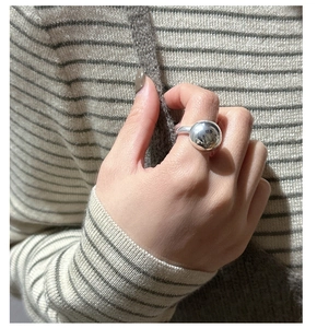 Detailed view of a wide dome S925 sterling silver ring worn on a finger