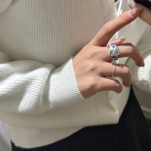 Minimalist S925 sterling silver buckle ring and slim band on a cozy knitted sweater