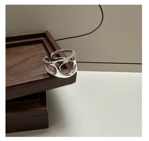 Macro detail of silver S925 hollow ring showcasing polished irregular minimalist design