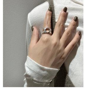 Close-up of a silver S925 hollow ring featuring three circular cutouts for a modern look