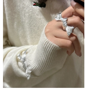 Macro view of S925 sterling silver butterfly ring and bracelet set with pleated texture
