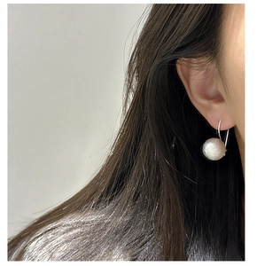 Detail of S925 sterling silver ball earring featuring a matte brushed texture finish