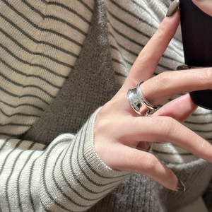 Minimalist S925 sterling silver wide band ring with irregular hammered texture on model
