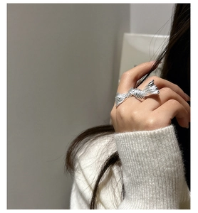 Close-up of S925 sterling silver butterfly ring with unique brushed texture on finger