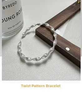 Detailed view of silver S925 twisted cuff bracelet with spiral texture in elegant setup