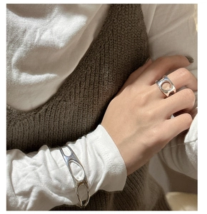 Close-up of S925 sterling silver hollow irregular ring and matching cuff bracelet
