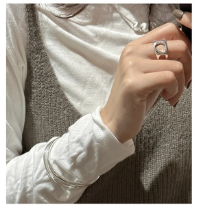 Close-up of S925 silver hollow irregular ring and multi-layer bangle set on model