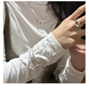 Detail of S925 sterling silver hollow cutout rings and bangles in liquid metal style