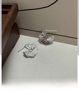 Detail showing S925 sterling silver hallmark on the pleated fan-shaped earring