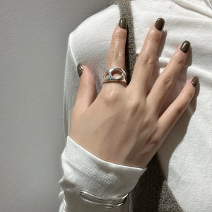 Minimalist S925 sterling silver hollow geometric ring on hand with silver cuff bracelet