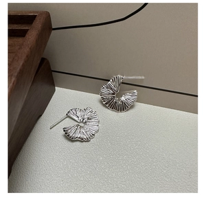 Detailed view of S925 sterling silver fan-shaped earrings with pleated radial texture