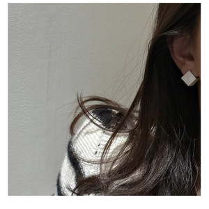 Gros plan de boucles d'oreilles cubes géométriques en argent S925 avec finition brossée