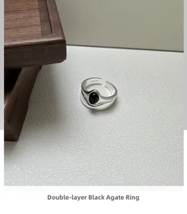 Macro shot of S925 sterling silver double-layer ring with an oval black agate stone