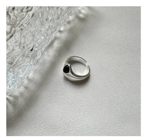 Detail view of S925 sterling silver stamp on minimalist black agate double-layer ring