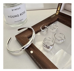 Minimalist irregular fluid metal jewelry set with streamlined silver bangle and rings