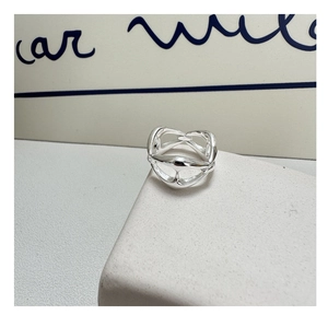 Detailed view of S925 sterling silver pig nose ring with multilayer hollow weaving on rock