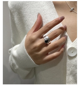 Detail of a minimalist S925 sterling silver double layer ring with oval black agate stone