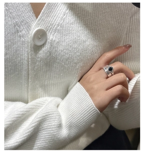Detail view of a double-layered S925 sterling silver ring with black onyx on hand