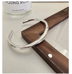 Detail showing S925 hallmark on the minimalist irregular wavy silver cuff bracelet