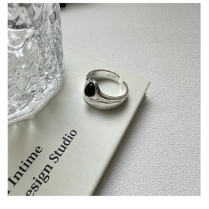 Detail view of S925 sterling silver stamp on minimalist double-layered onyx ring