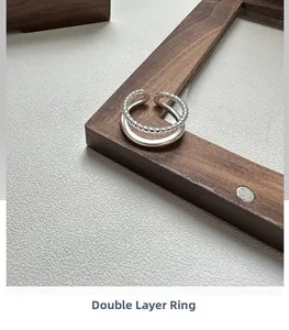 Macro detail of S925 sterling silver double-layer ring with twisted rope design and smooth band