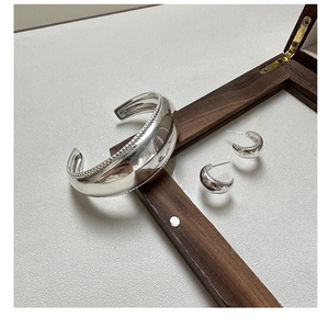 Polished S925 silver wide cuff bracelet and matching C-shape earrings with milgrain edges