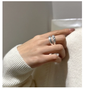 Close-up of S925 sterling silver twisted croissant ring on female finger