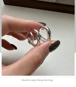Macro view of S925 sterling silver double-layer hoop earrings with wavy texture