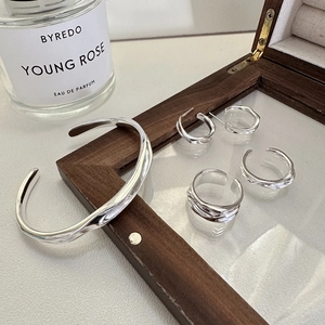 Irregular wavy silver jewelry set with minimalist textured bangle, rings and earrings