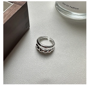 Close-up of S925 sterling silver twisted ring with elegant polished double layer texture