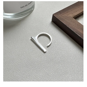 Close-up of minimalist S925 sterling silver geometric bar ring with polished finish
