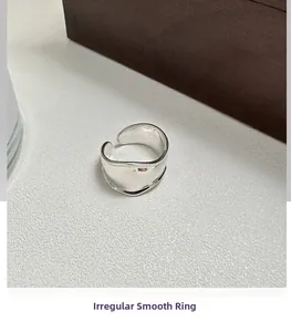 Detailed view of polished S925 sterling silver ring with irregular curved surface