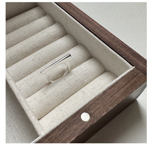 Macro detail of S925 sterling silver stamp on minimalist bar ring inside a jewelry box