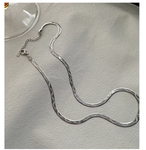 Detail of S925 sterling silver snake chain showing textured wave patterns and lobster clasp