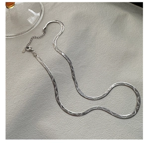 Detail of S925 sterling silver snake chain necklace with embossed pattern and lobster clasp