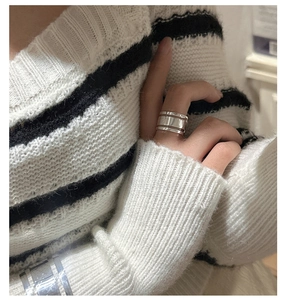 Close-up of minimalist S925 sterling silver wide ring with triple layer grooved texture