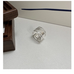 Macro shot of silver wide open ring showing smooth polished surface and RECIIS engraving
