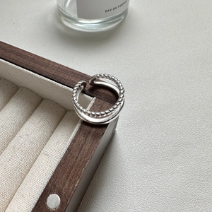 Elegant S925 sterling silver double-layer twist ring displayed on a wooden jewelry tray