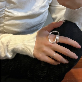 Detail showing layered styling of minimalist S925 silver rings with abstract wavy lines