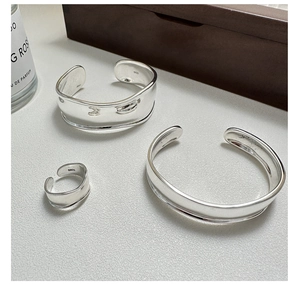Detailed view of polished S925 sterling silver open bangles and matching ring set