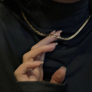 Minimalist S925 sterling silver golden W snake chain necklace on black sweater
