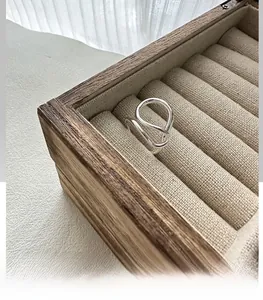Macro view of minimalist S925 sterling silver layered ring on a jewelry box liner