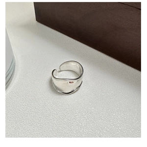 Detailed macro view of an irregular wave S925 sterling silver wide band open ring