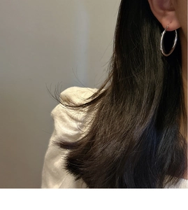 Polished S925 sterling silver hoop earrings worn by a model for a stylish minimalist look