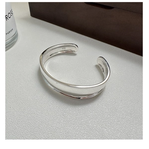 Close-up of S925 sterling silver hallmark on the inner band of the wide open bangle